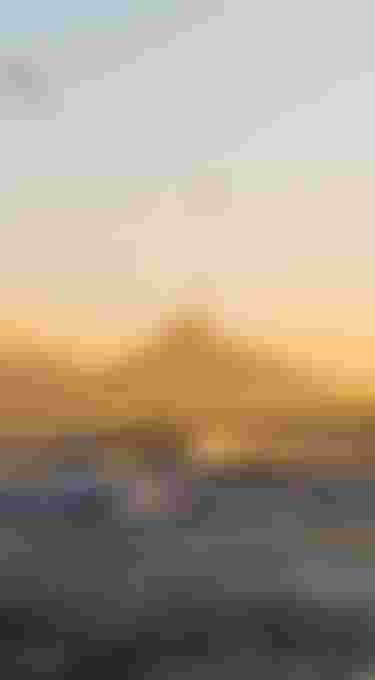 Two Kiteboarders jumping high during sundowner